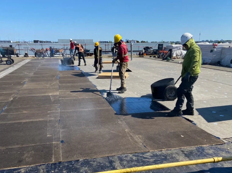 One Roofing Services team working on a building